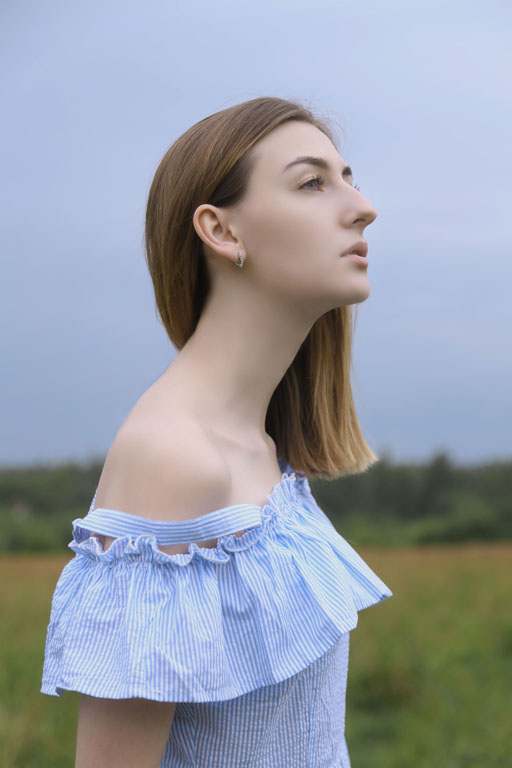 Portrait of meditative beautiful girl with long neck line standing